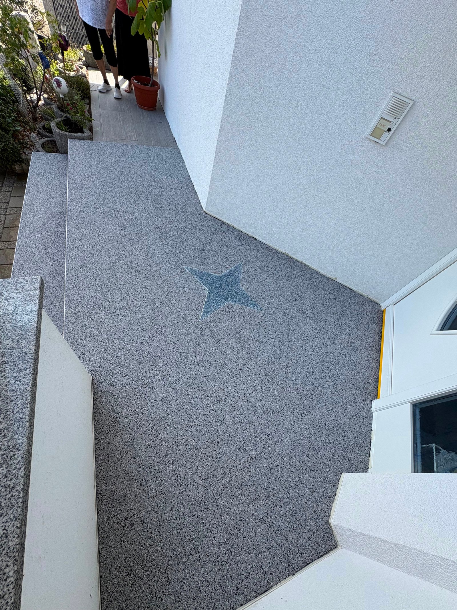 Steinteppich Hauseingang mit Stern-Einlage